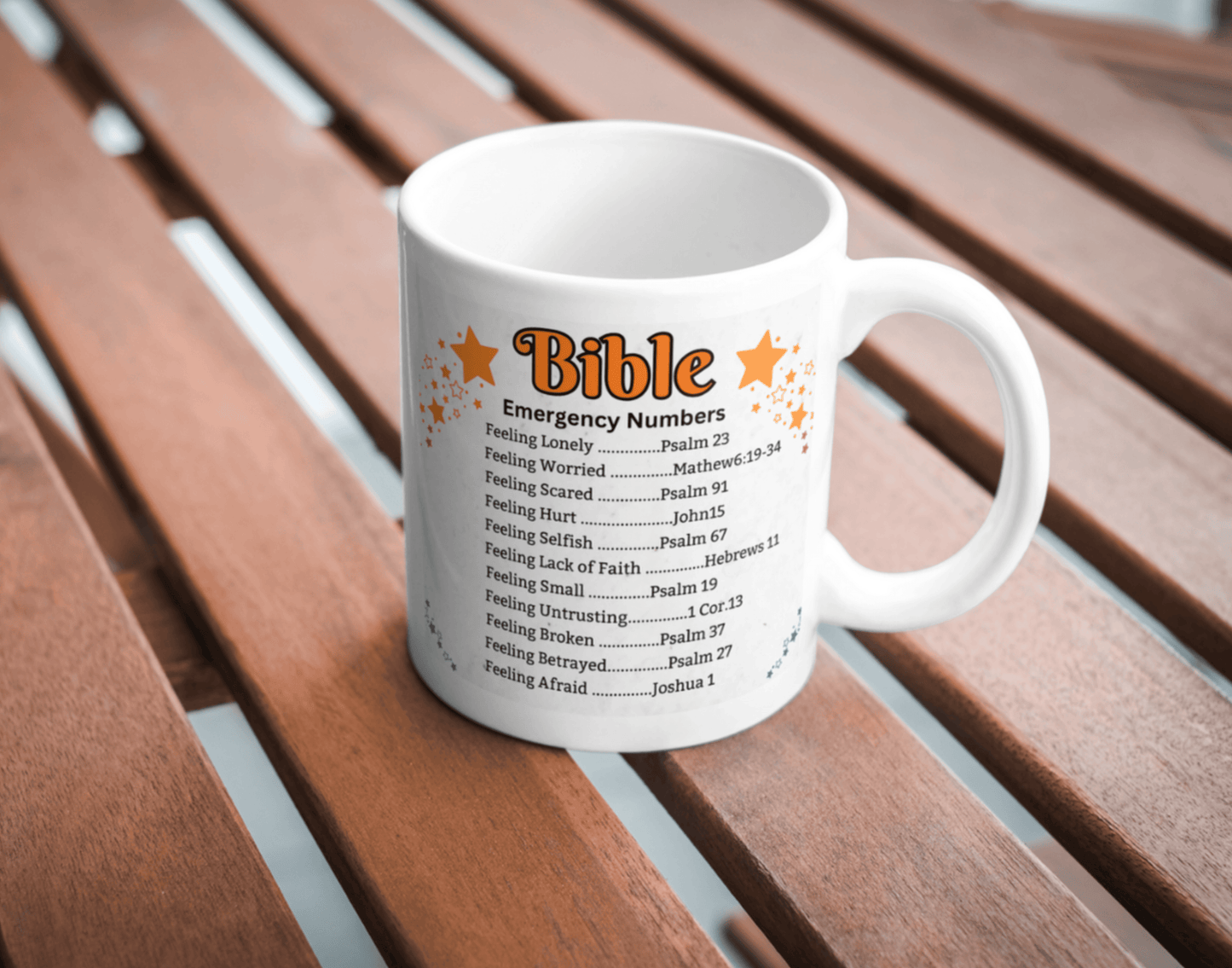 Faith-inspired coffee mug featuring Bible emergency numbers with verses for various emotions, adorned with festive pinecones and berries.