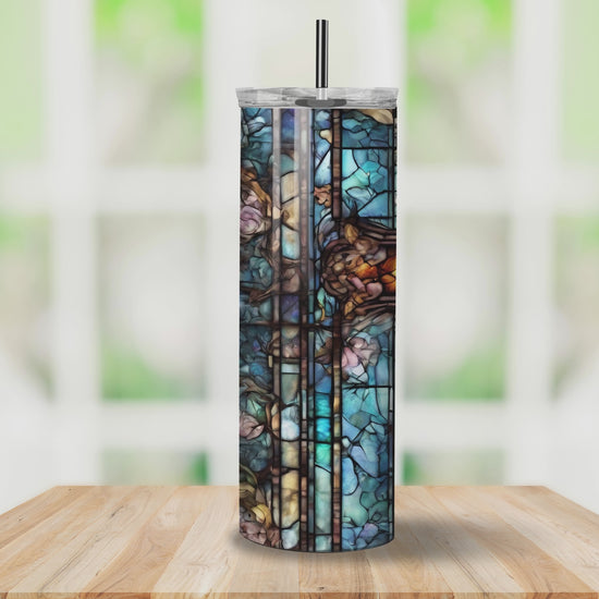 Stained glass cross tumbler with vibrant multicolored design, featuring a faith-inspired pattern. Ideal for keeping drinks hot or cold.